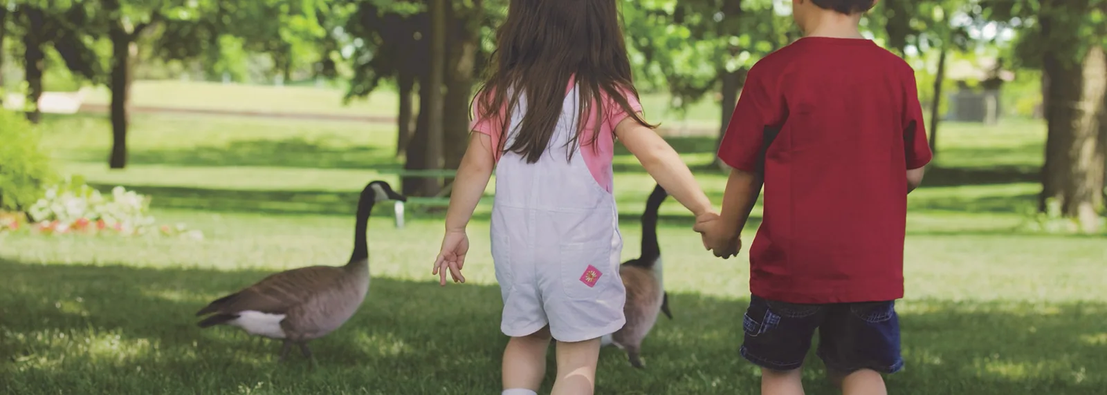 Children walking through a shaded green space in the Acadia community near Greenville, South Carolina.