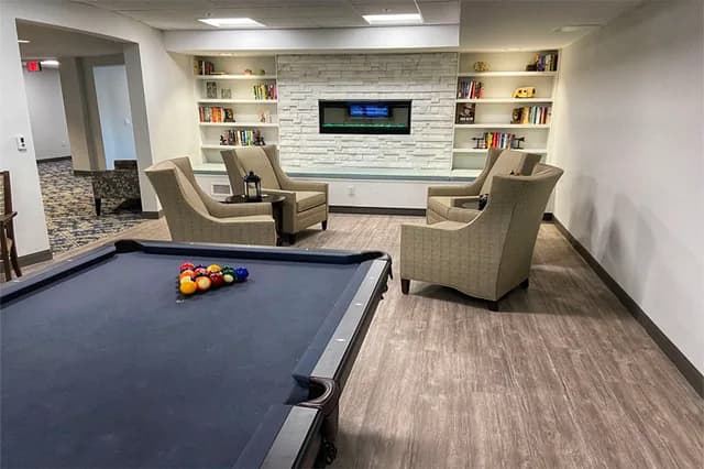 Pool table and fireplace lounge area at Maple Brook Terrace in Greenville, SC.