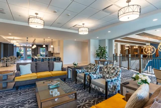 Modern common area and lounge at Merrill Gardens at Greenville senior living community with comfortable seating.