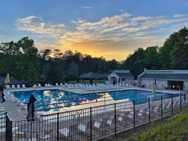 Sunset view of the swimming pool and deck area at the Pebble Creek neighborhood in Taylors, SC.