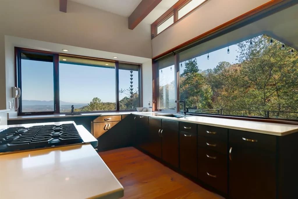 Modern kitchen with large windows overlooking scenic mountain views in a Ridges at Paris Mountain home.