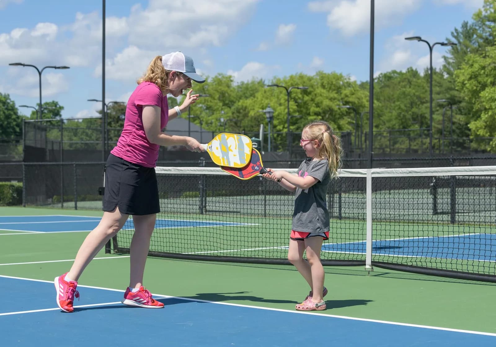 Woman and young girl playing pickleball on the courts at Thornblade Club.