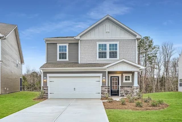 Exterior view of a modern two-story single-family home with a garage at the Villas of North Valley community.